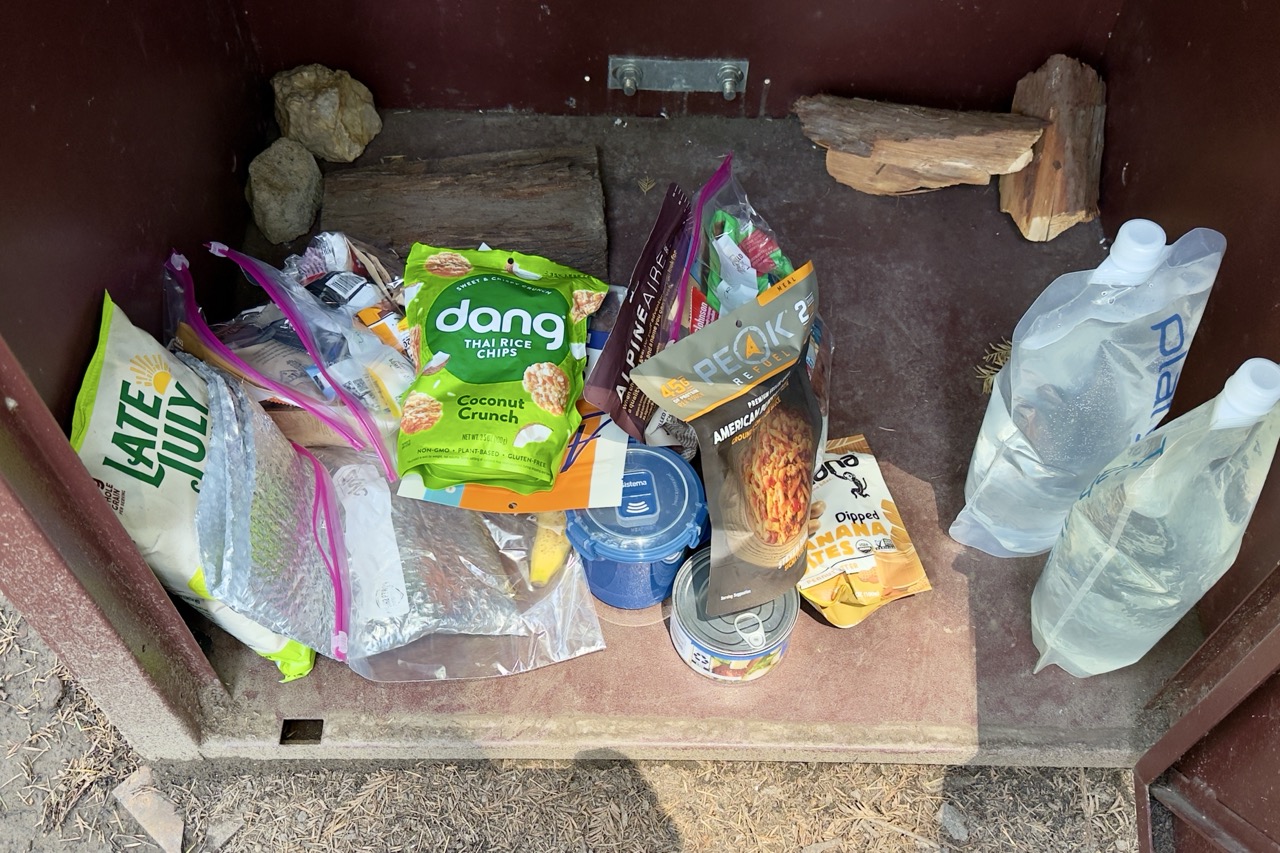 Food stashed inside a brown metal critter cabinet.