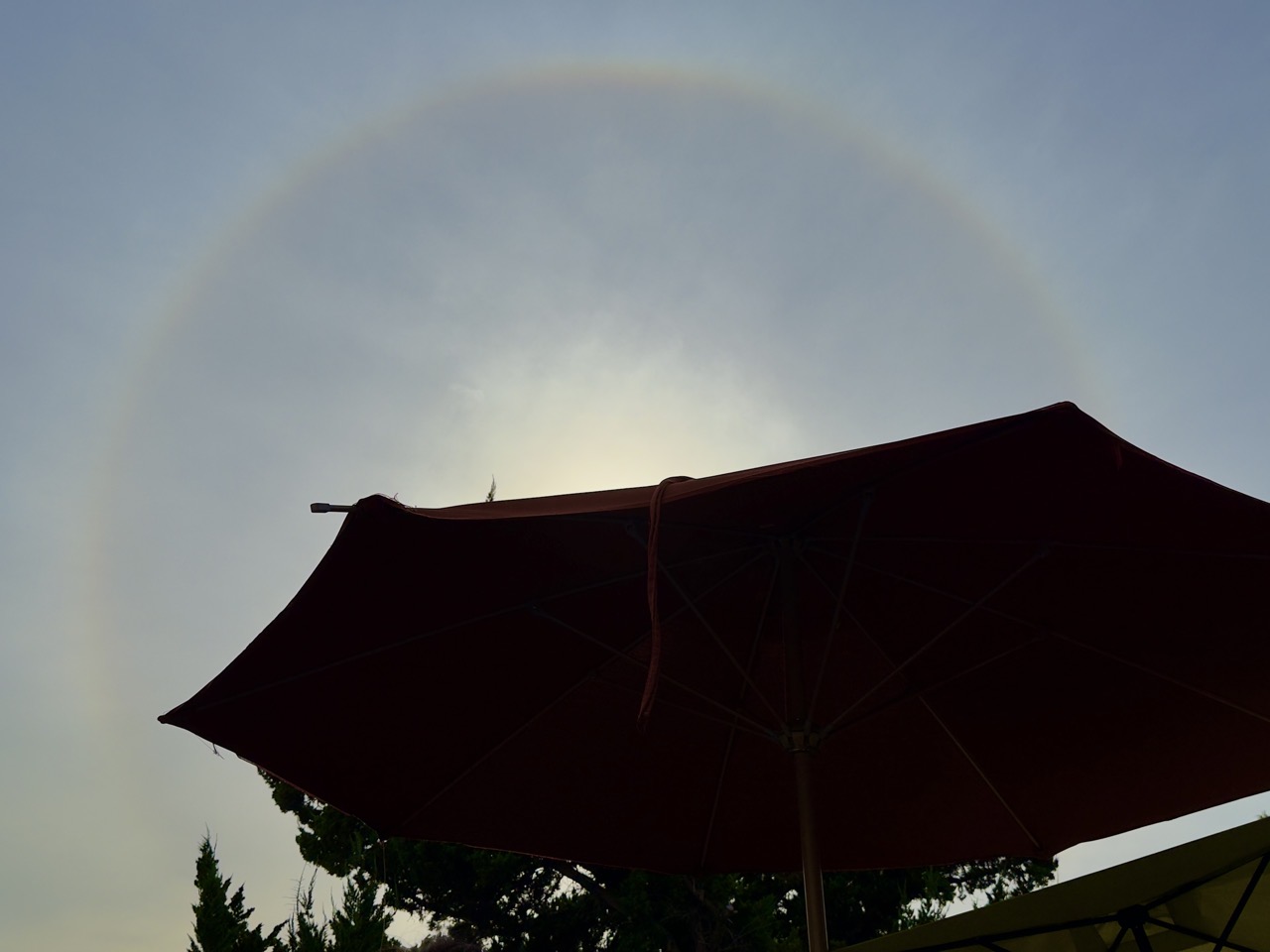 A sun halo, the sun is behind a patio umbrella.