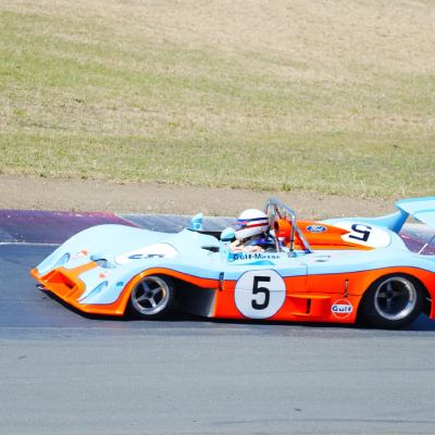 A powder-blue and orange Gulf Mirage prototype, number 5, cornering.